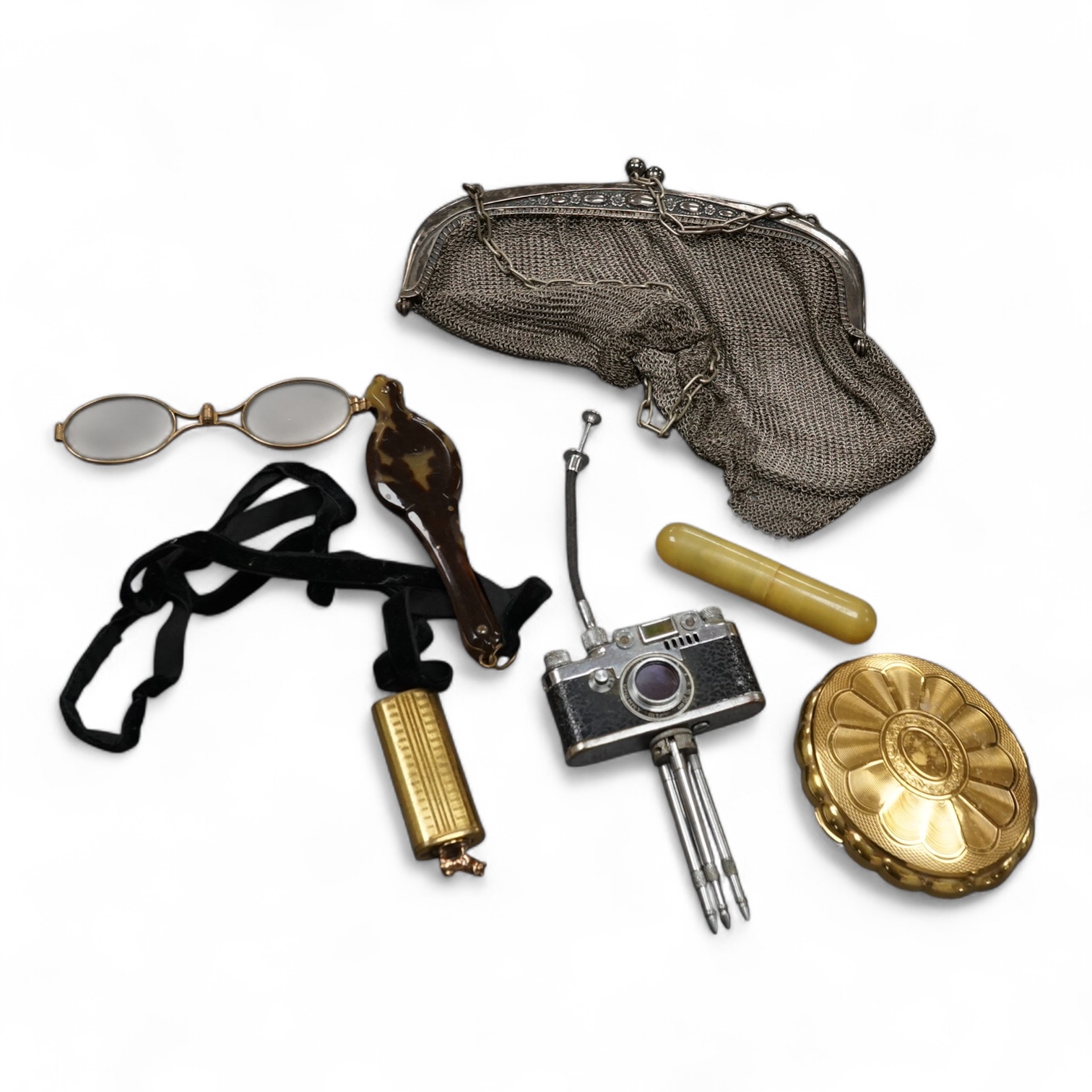 A miniature camera on stand, a lorgnette, mesh evening purse, compact, scent bottle and manicure set (6), purse 20cm high. Condition - camera worn, other items good